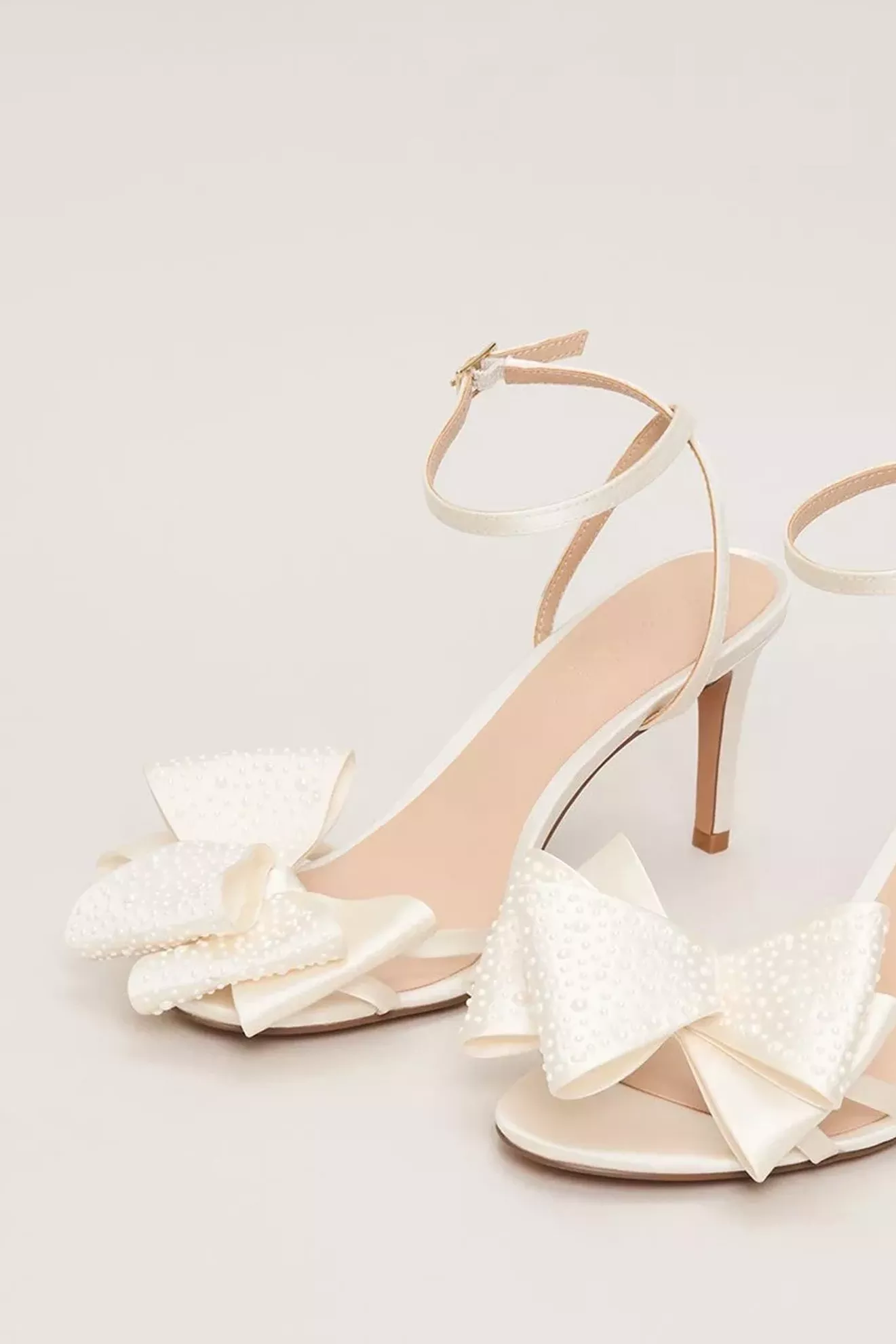 cream high heels with bow front