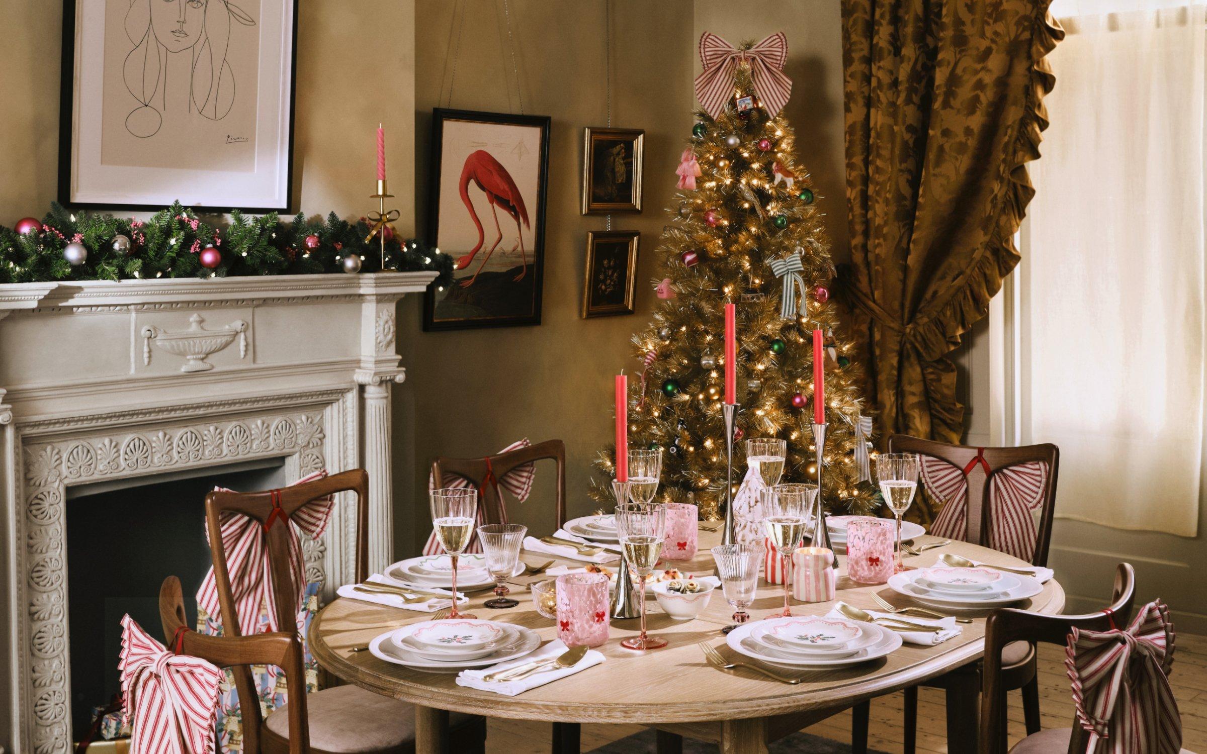 Dining room table dressed with a red warm Christmas setting