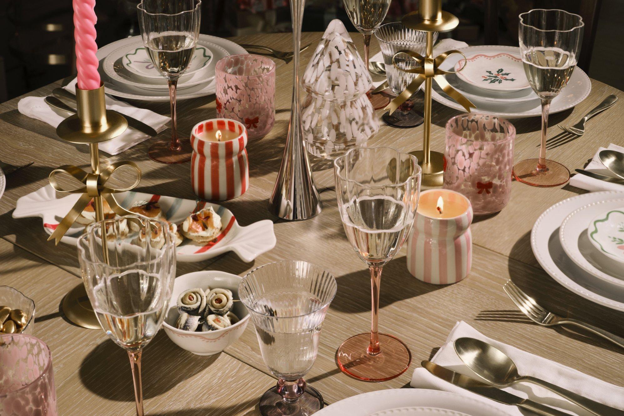 close up of lots of table dressed with, candles, glasses and tableware