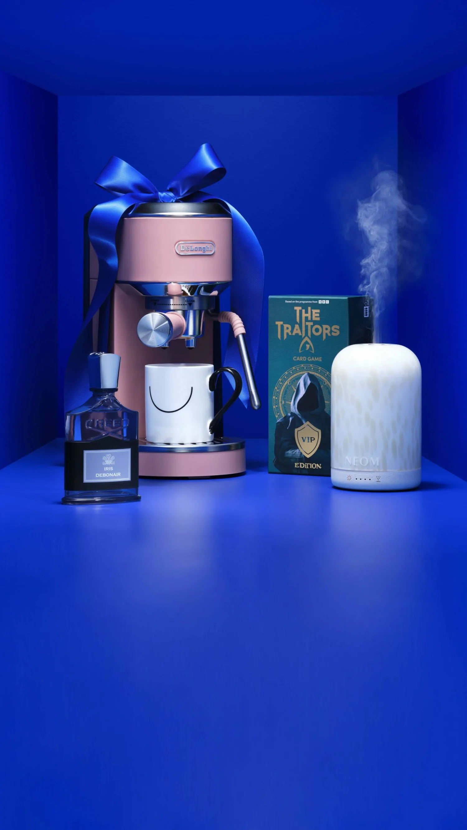 Pink De’Longhi espresso machine gift set with ribbon, Creed perfume, NEOM diffuser and The Traitors card game