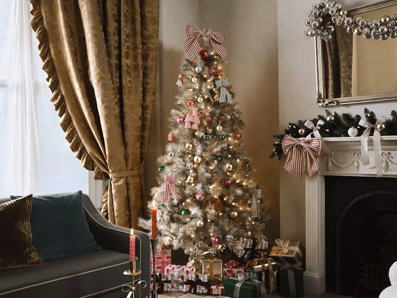Christmas tree next to sofa and fireplace