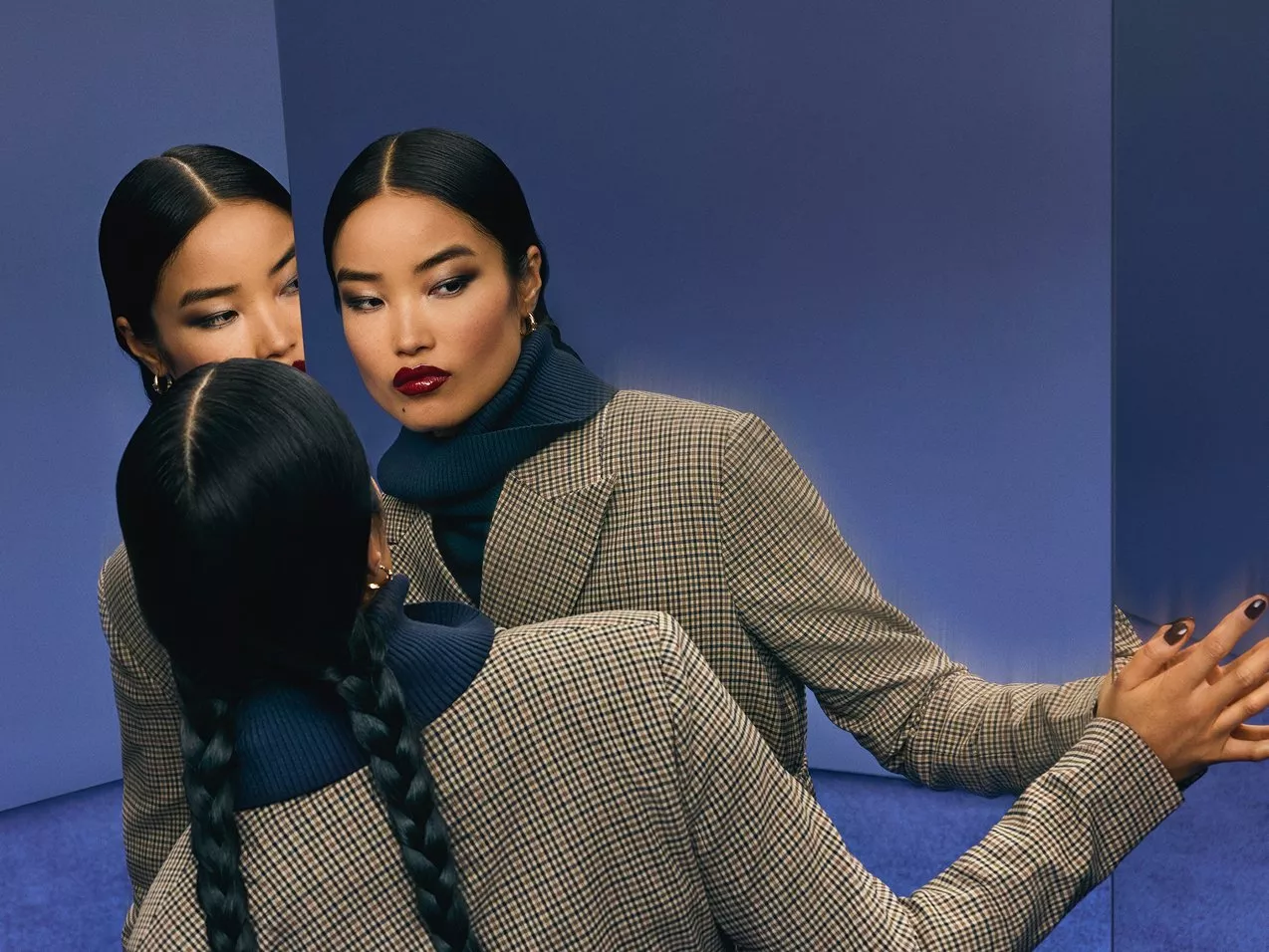 Lady looking in mirror with multiple reflections 