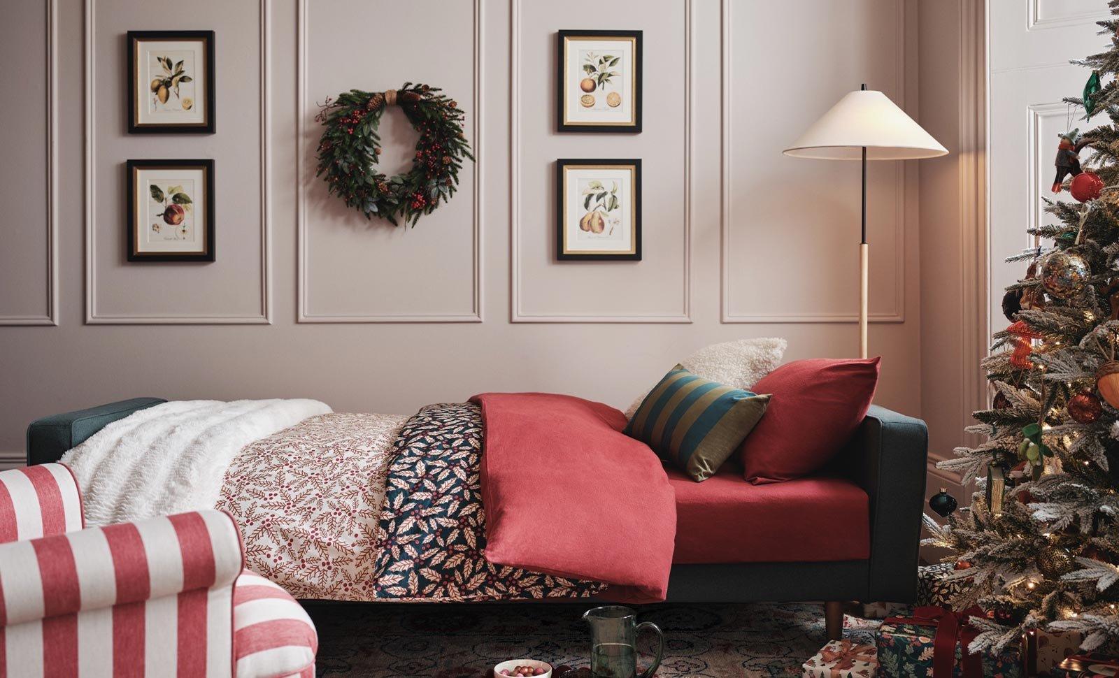 Christmas themed bedding in decorated room