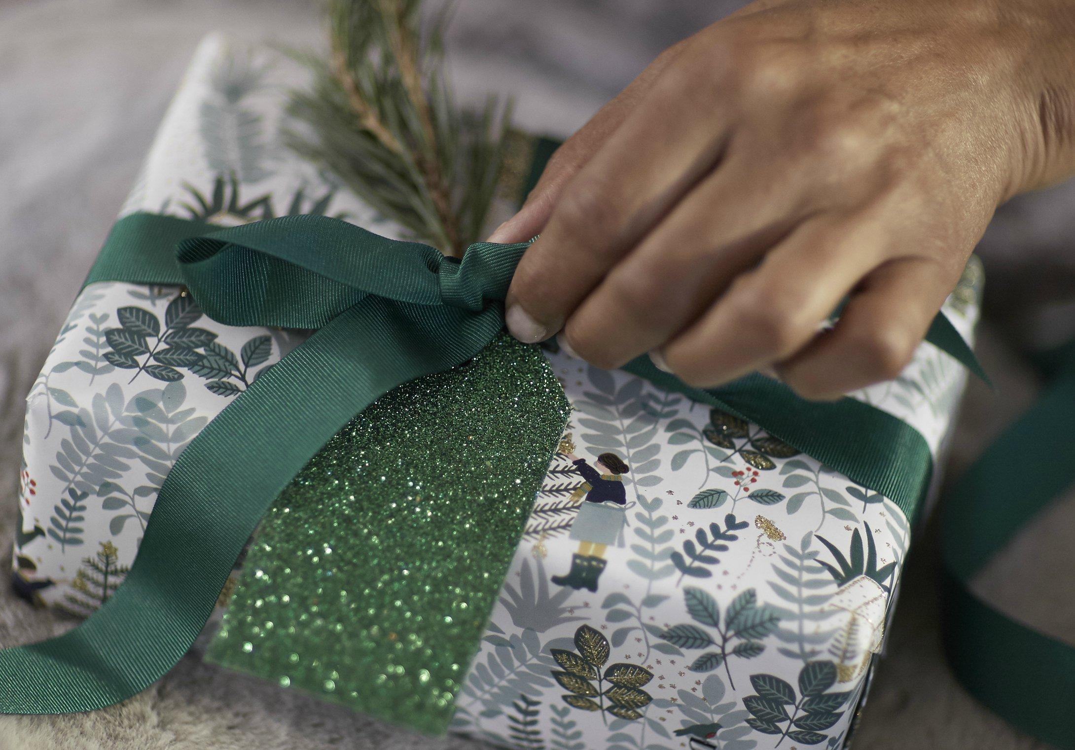 Person wrapping a gift